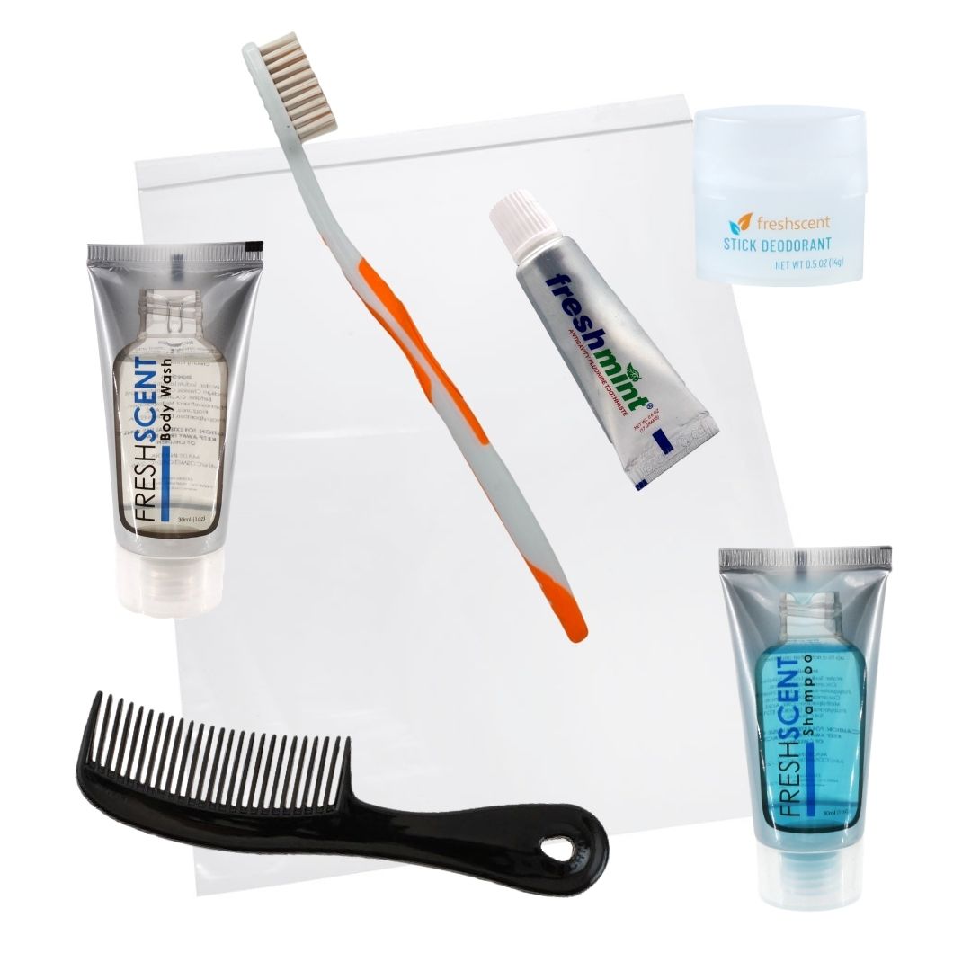 6 pc hygiene kit containing a black comb, toothbrush, toothpaste, shampoo, body wash, and deodorant, pre-assembled in a zip-close bag.